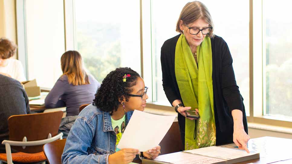 Judith Miller with student in Rose Library