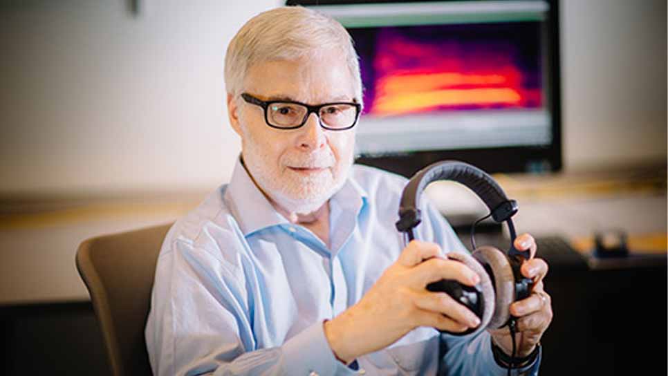 Harold Gouzoules in lab with headphones