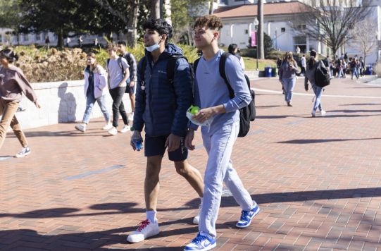 students walking through campus outside
